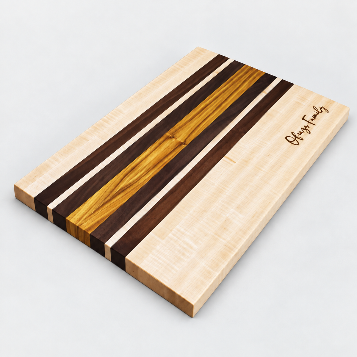 Handcrafted Curly Maple & Canary Wood Cutting Board on a light gray background