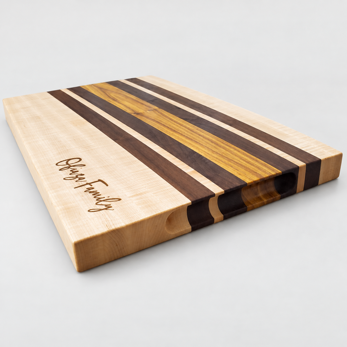 Handcrafted Curly Maple & Canary Wood Cutting Board, detail view on a light gray background