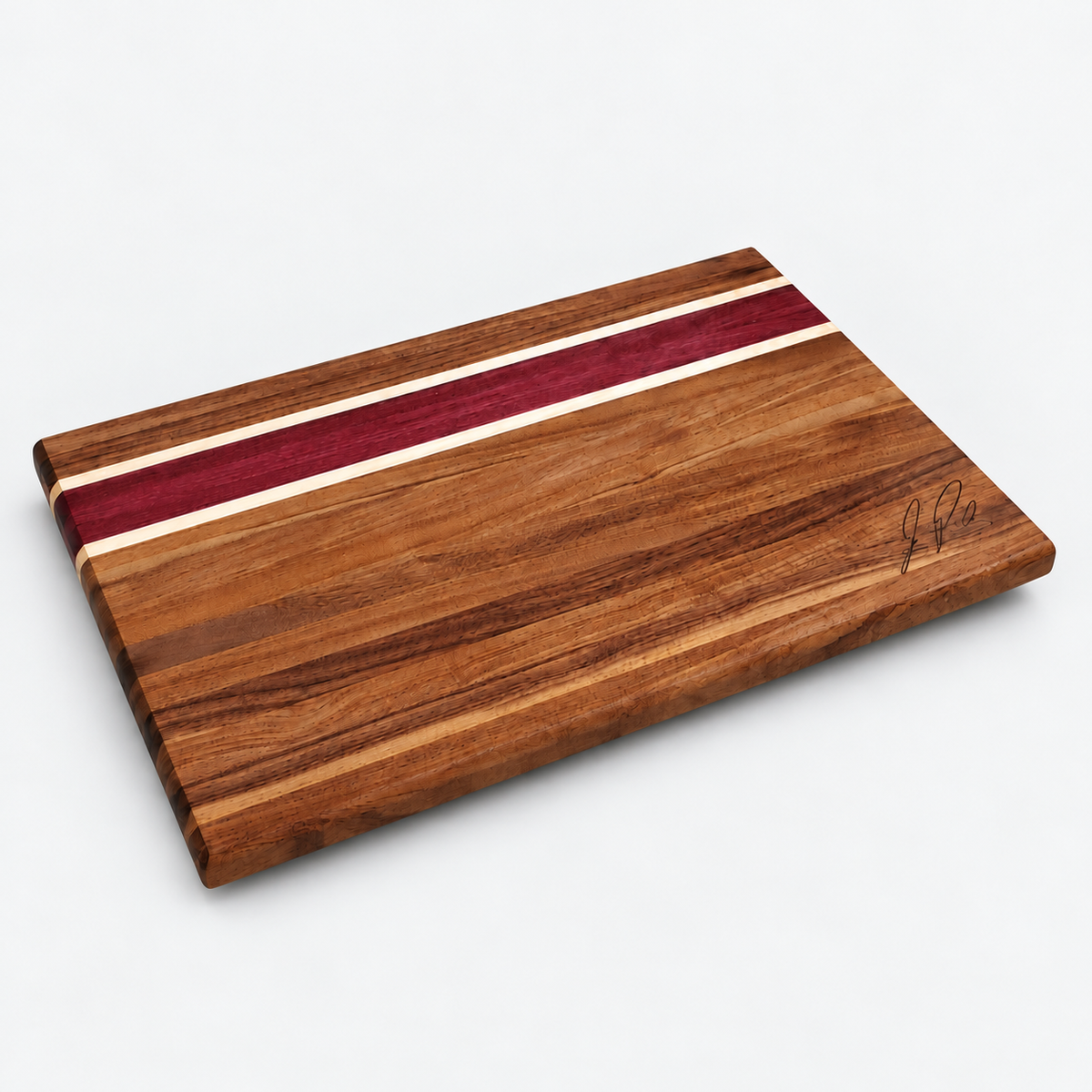 Walnut and purpleheart cutting board centered on a light gray background