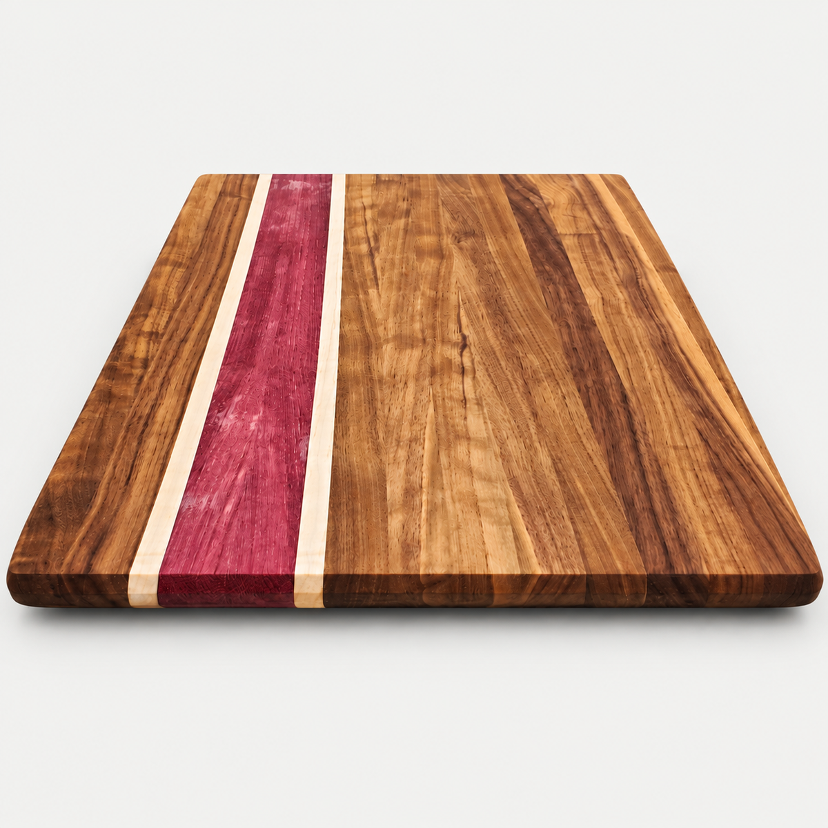 Walnut and purpleheart cutting board, detail view 2, on a light gray background