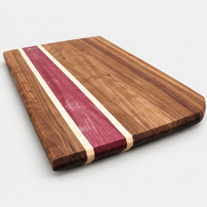 Walnut and purpleheart cutting board, detail view 3, on a light gray background