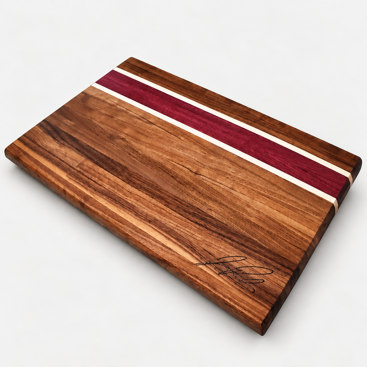 Walnut and purpleheart cutting board, detail view 4, on a light gray background